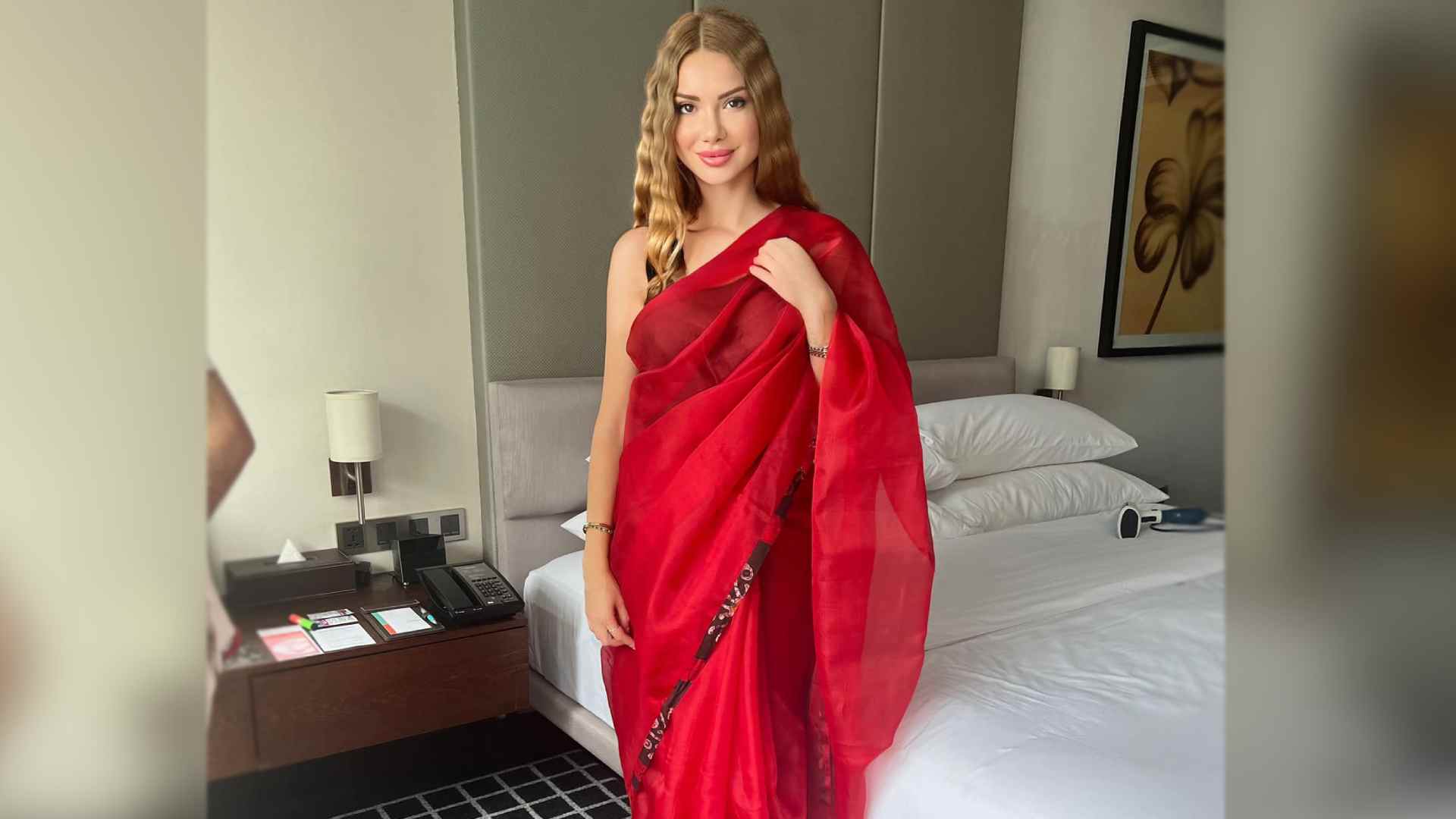 Otilia charms in crimson sari