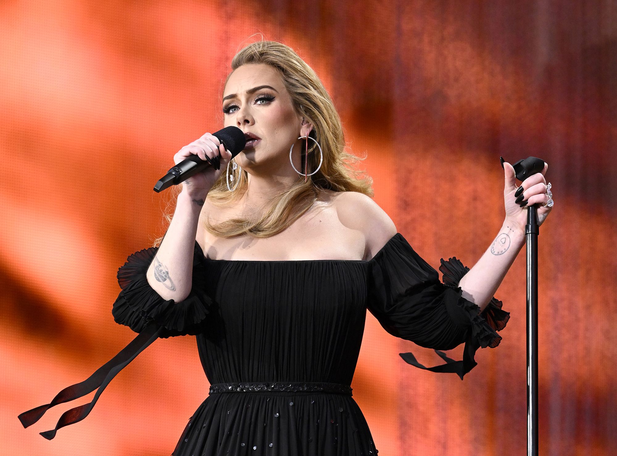 Adele speaks out against fans throwing objects at musicians on stage 