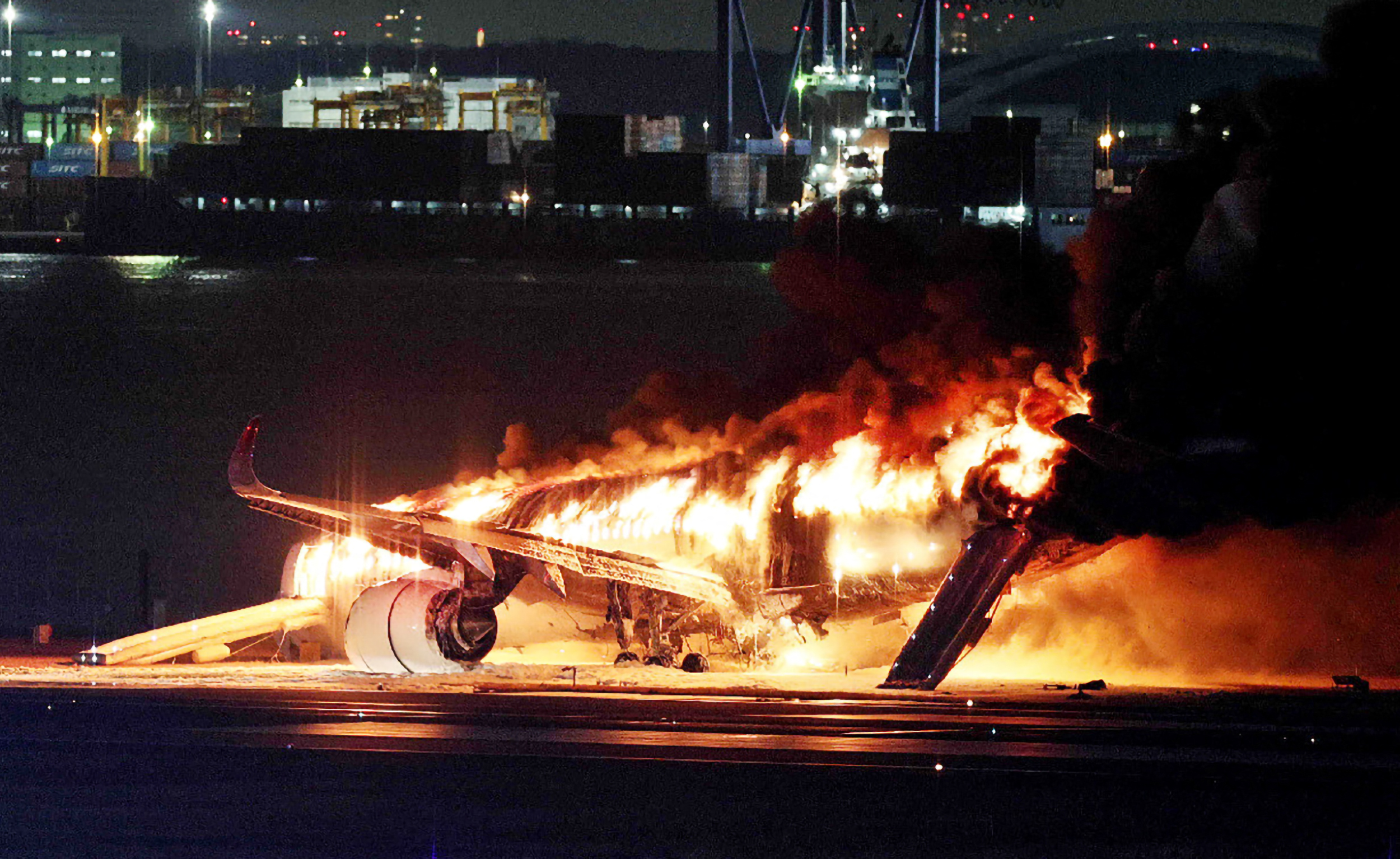 Japan Airlines plane on fire on runway at Tokyo's Haneda airport
