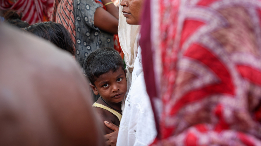 A boy stands with his mother inside a makeshift shelter camp in Goalpara district in the northeastern state of Assam, India, July 18, 2025. Photo: Reuters