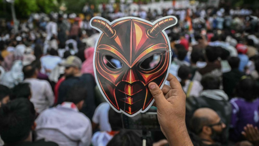 A Cockroach Janta Party (CJP) supporter holds a cockroach mask during a protest over alleged irregularities in the country's major examinations, in New Delhi on Saturday. Photo: AFP