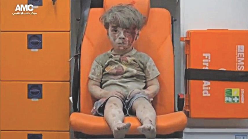 Bloodied face of the injured boy, airstrike in aleppo, syria war, innocent boy