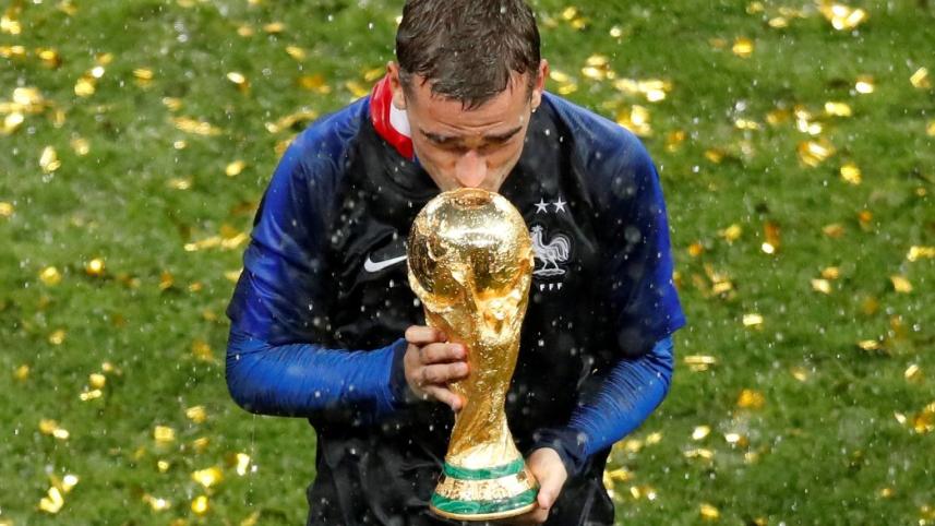 France's Antoine Griezmann kisses the trophy to celebrate winning the World Cup 2018