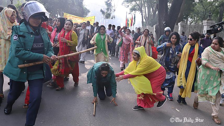A BNP activist rushes in to help a police woman