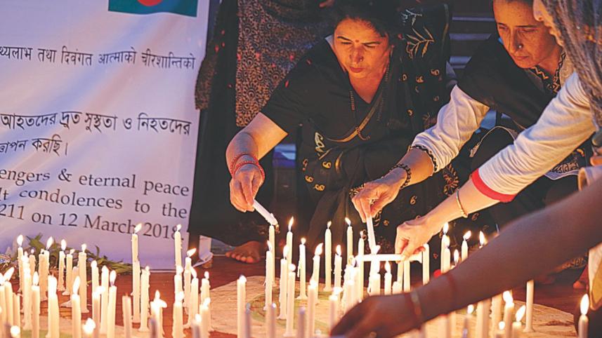 Candles are lit at Central Shaheed Minar for US-Bangla Airlines Plane Crash 