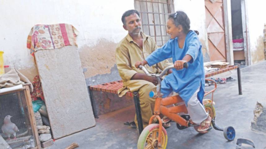 Rickshaw driver Rasheed with his daughter