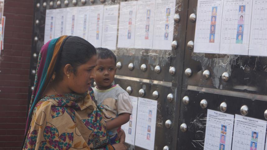 An apparel worker is gazing at the list of sacked labourers