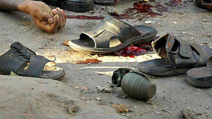 An unexploded grenade amid shoes and a victim after the attack on August 21