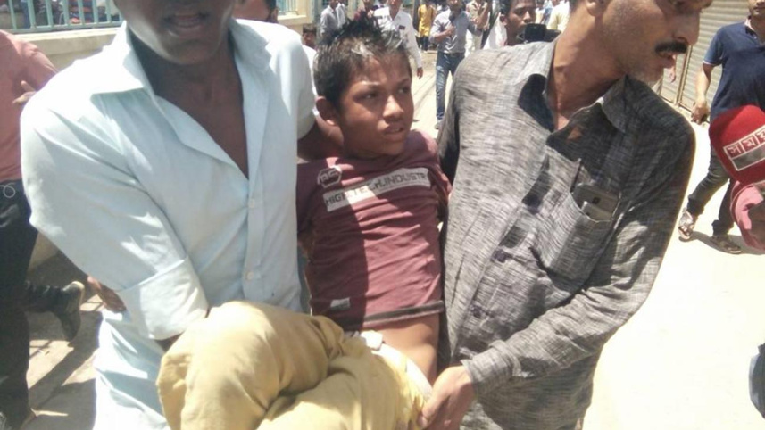 Boy who fell sick during sound grenade explosions in Narayanganj city on Saturday, August 27 is being carried by locals.