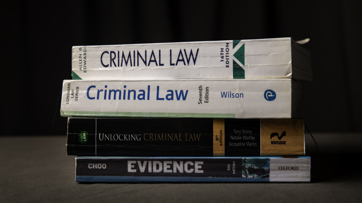 A stack of books on the practice of criminal law. 