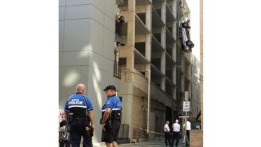 Bad parking job, Austin garage, dangling car, off beat