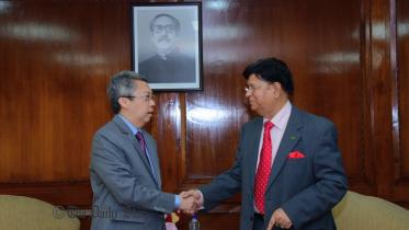 Consul of Singapore in Bangladesh William Chik shakes hands with the new Foreign Minister AK Abdul Momen