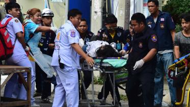 Thai rescue workers attend to an injured victim