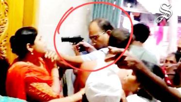 DB officer points gun at suspect's wife