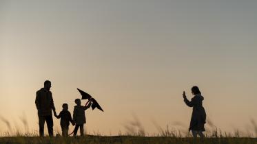 family-silhouettes-having-fun-sunset-full-shot.jpg
