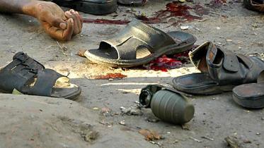 An unexploded grenade amid shoes and a victim after the attack on August 21