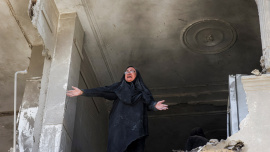 A woman reacts inside her brother's home, which was damaged by an airstrike, in Tehran, Iran, March 30. Photo: Reuters