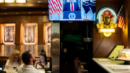 A customer watches U.S. President Donald Trump address the nation on the Iran crisis from the White House in Washington, D.C., on screen at Brooklyn Diner in Times Square, New York, U.S., April 1, 2026. Photo: Reuters 