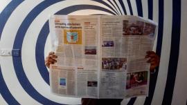 Person reading a newspaper. 