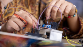 Person building a robot